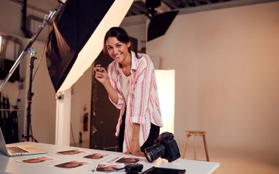 Portrait Of Female Photographer Editing Images From Photo Shoot In Studio