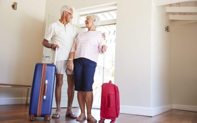 Senior Couple Arriving At Summer Vacation Rental
